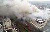 Smoke rises above a multi-story shopping mall in the Siberian city of Kemerovo on March 25, 2018.