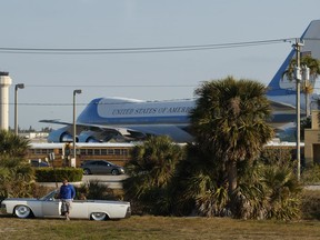 Air Force One is seen on the tarmac at Palm Beach International Airport in West Palm Beach, Fla., Sunday, March 25, 2018, from the media van traveling in a motorcade with President Donald Trump.