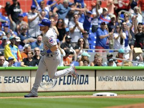 Chicago Cubs center fielder Ian Happ rounds third base after hitting a home run in the first inning of a baseball game against the Miami Marlins, in Miami Thursday, March 29, 2018.