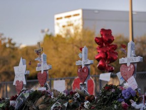 This Feb. 19, 2018 file photo shows a makeshift memorial outside Marjory Stoneman Douglas High School, where 17 students and faculty were killed in a mass shooting in Parkland, Fla. Parkland city's historian Jeff Schwartz is setting a plan in motion to collect, archive and preserve the Marjory Stoneman Douglas mementos. Meanwhile, school administrators have vowed to build a memorial after the demolition of the building where the Feb. 14 attack took place.