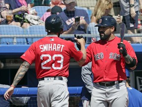 After hitting a home run in the fifth inning against the Toronto Blue Jays, Boston Red Sox's Blake Swihart (23) gets a fist-bump from teammate Sandy Leon, right, in a spring baseball exhibition game, Monday, March 12, 2018, in Dunedin, Fla.