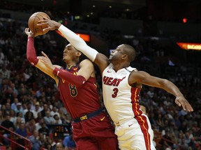 Miami Heat guard Dwyane Wade (3) blocks a shot by Cleveland Cavaliers guard Jordan Clarkson (8) in the first quarter during an NBA basketball game, Tuesday, March 27, 2018, in Miami.