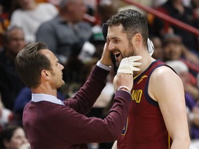 Cleveland Cavaliers center Kevin Love (0) is attended to after a first quarter injury during play against the Miami Heat in an NBA basketball game, Tuesday, March 27, 2018, in Miami. The Heat won the game 98-79.