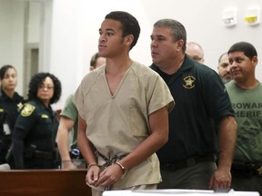 Zachary Cruz, brother of Nikolas Cruz, who's accused of killing 17 students and staff members at the school Feb. 14, walks into court in Fort Lauderdale, Fla., Thursday, March 29, 2018. He pleaded no contest to trespassing on the campus where the deadly rampage happened and was sentenced to time served and six months of probation.