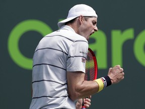 John Isner reacts after winning a point against Marin Cilic, of Croatia, during the Miami Open tennis tournament, Tuesday, March 27, 2018, in Key Biscayne, Fla. Isner won 7-6 (0), 6-3.