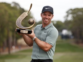 Paul Casey holds up the champion's trophy after winning the Valspar Championship golf tournament Sunday, March 11, 2018, in Palm Harbor, Fla.