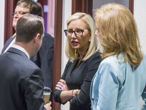 Florida Sen. Lauren Book (D-Plantation), center, speaks with Rep. Jared Even Moskowitz (D-Coral Springs), left, and Rep. Kristin Diane Jacobs (D-Coconut Creek) on the House floor during questioning on the school safety bill at the Florida Capital in Tallahassee, Fla., Tuesday March 6, 2018.