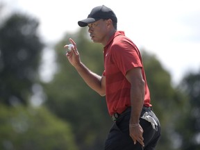 Tiger Woods acknowledges the crowd after making a putt on the second green during the final round of the Arnold Palmer Invitational golf tournament Sunday, March 18, 2018, in Orlando, Fla.