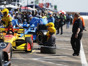 IndyCar crew do last minute adjustments to cars before the start of the morning practice session on the first day of the Firestone Grand Prix of St. Petersburg, Fla., Friday, March 9, 2018.