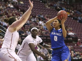 Buffalo's Summer Hemphill cuts between Florida State's Chatrice White, left, and Shakayla Thomas as she drives to the basket in the second round game of the NCAA women's college basketball tournament, Monday, March 19, 2018, in Tallahassee, Fla.