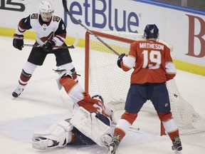 Arizona Coyotes center Clayton Keller (9) scores a goal as Florida Panthers goaltender James Reimer (34) and defenseman Mike Matheson (19) defend during the first period of an NHL hockey game in Sunrise, Fla., Saturday, March 24, 2018.