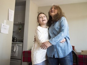 Arzu Ozkose dances with her daughter Alara, 10, who has Dravet syndrome and is enrolled in a Sick Kids trial using high-CBD cannabis oil at their home in Toronto on Saturday, March 24, 2018.