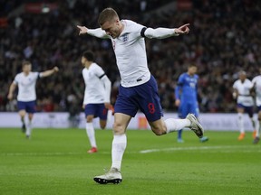 England's Jamie Vardy celebrates after scoring his side's opening goal during the international friendly soccer match between England and Italy at the Wembley Stadium in London, Tuesday, March 27, 2018.