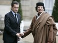 In this Dec. 10 2007 file photo, French President Nicolas Sarkozy, left, greets Libyan leader Col. Moammar Gadhafi upon his arrival at the Elysee Palace, in Paris. Former French President Nicolas Sarkozy was placed in custody on Tuesday March 20, 2018 as part of an investigation that he received millions of euros in illegal financing from the regime of the late Libyan leader.