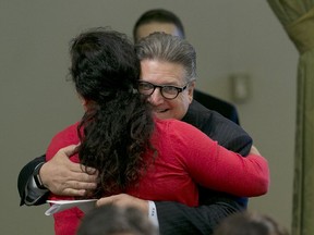 FILE  - In this Aug. 31, 2017 file photo, State Sen. Bob Hertzberg, D-Van Nuys, hugs Assemblywoman Lorena Gonzalez Fletcher, D-San Diego, after his storm water bill was approved by the Assembly in Sacramento, Calif. Hertzberg has been told to stop hugging people after a sexual misconduct investigation concluded his behavior made multiple colleagues uncomfortable. Hertzberg was formally reprimanded Tuesday, March 6, 2018, by the Senate Rules Committee. The Los Angeles-area says he will respect the request not to hug people.