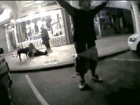In this May 5, 2017 image  from a police body worn video camera released by the Los Angeles County District Attorney's Office, Brendon Glenn is shown with his arms in the air yelling before being shot by police near the Venice boardwalk in Los Angeles. A police officer who shot and killed an unarmed homeless man near the Venice boardwalk last year violated departmental policy, the Police Commission ruled Tuesday, March 6, 2018. The civilian panel concluded that Officer Clifford Proctor wasn't justified in shooting Brendon Glenn twice in the back as Glenn, 29, was on the ground last May 5. The officers tried to detain Glenn after reports that he had been harassing people and they saw him struggling with a bar bouncer, police said. (Los Angeles District Attorney's Office via AP)