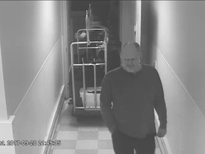 In this Sept. 28, 2017, security camera image released by MGM Resorts, Stephen Paddock is followed by a bellman in a hallway, at the Mandalay Bay hotel in Las Vegas. The newly released video shows the man who killed 58 people on the Las Vegas Strip moving around a casino before the attack, gambling, bringing suitcases into his room at Mandalay Bay but doing nothing that would obviously raise suspicions. (MGM Resorts via AP)