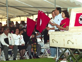 FILE - In this April 28, 1993, file photo, Dolores Huerta, right, holds a flag at the start of a rosary for United Farm Workers leader Cesar Chavez in Delano, Calif. Second from left and gesturing is Chavez' widow, Helen Chavez. Huerta, the social activist who formed a farm workers union with César Chávez and whose "Si, Se Puede" chant inspired Barack Obama's 2008 presidential campaign slogan, is the subject of a new PBS documentary. The film "Dolores" examines the life of the New Mexico-born Mexican-American reformer from her time as a tireless United Farm Workers leader and a campaign volunteer for Sen. Robert Kennedy's 1968 presidential run.