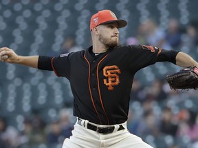 San Francisco Giants pitcher Chris Stratton throws against the Oakland Athletics during the first inning of a spring baseball game in San Francisco, Tuesday, March 27, 2018.