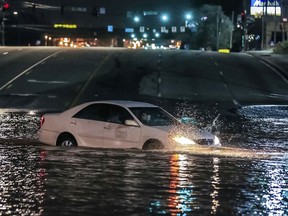 A car crashes into a water main break in Doraville, Ga., Wednesday, March 7, 2018. The massive water main break Wednesday morning left residents outside Atlanta without water, sent water gushing into neighborhoods and flooded a major highway, closing businesses miles away and prompting schools to close.