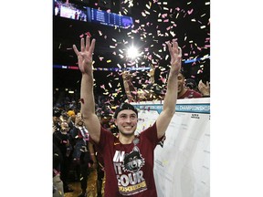 March 24, 2018 Atlanta: Confetti falls as Loyola-Chicago guard Ben Richardson holds up four fingers on each hand, for Final Four, while celebrating the team's 78-62 win over Kansas State in the regional final of the NCAA men's college basketball tournament Saturday, March 24, 2018, in Atlanta.