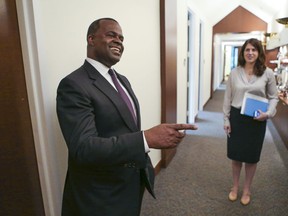 This Sept. 2, 2015 photo shows mayor Kasim Reed, left, and press secretary,  Jenna Garland, right in Atlanta.  A profanity-laced exchange of text messages shows that Garland advised a city official to be "as unhelpful as possible" in responding to a public records request. WSB-TV reports that the spokeswoman also advised the official to "drag this out" as long as possible and provide information in the most confusing format available. The station had requested records for a 2017 story that eventually revealed that several city council members had failed to fully pay their water bills.