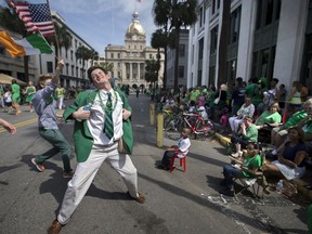 FILE- In this March 17, 2015 file photo Lamar Lester III dances while marching with the Doherty Clan during the 191st St. Patrick's Day parade in Savannah, Ga. Vice President Mike Pence is planning to attend Savannah's St. Patrick's Day parade.