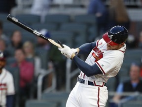 Atlanta Braves first baseman Freddie Freeman (5) breaks his bat hitting a foul ball in the first inning of a major league baseball game against the Philadelphia Phillies, Friday, March 30, 2018, in Atlanta.