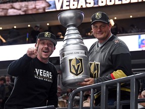 Golden Knights fans Mike Forizs, left, and Derek Frank pose with a homemade version of the Stanley Cup before the Knights' game against the Los Angeles Kings in Las Vegas on Feb. 27, 2018.