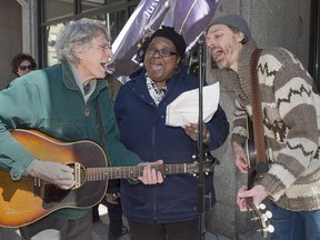 Joel Plaskett, right, and his father Bill Plaskett perform with community activist Lynn Jones in Halifax on Thursday, March 29, 2018 in support of seven black janitorial workers who were set to lose their jobs at the end of the month when their cleaning contract ends and a new contractor takes over. The workers were fired after indicating plans to file a human rights complaint. The workers have been given other work by their employer.