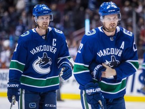 Vancouver Canucks forwards Henrik Sedin, left, and Daniel Sedin warm up for a game against the Anaheim Ducks on March 27.