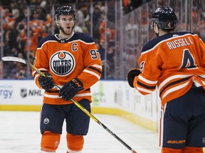 Connor McDavid and Oilers teammate Kris Russell celebrate a goal against the Minnesota Wild during second-period action in Edmonton on Saturday night.