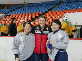 Hayley Wickenheiser poses with members of the North Korean women's hockey team in Pyongyang, North Korea, on March 5.