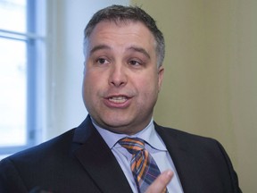 Quebec Education and Family Minister Sebastien Proulx responds to reporters questions, Friday, June 16, 2017 at the legislature in Quebec City. A Quebec publishing house says it has removed a French grammar exercise after complaints it contained a racial slur.