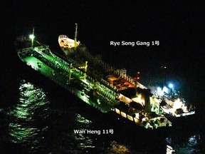 This Feb. 13, 2018, image released by Japan's Ministry of Defense shows what it says is the Belize-flagged tanker Wan Heng 11 next to the North Korean-flagged Rye Song Gang 1 in the East China Sea carrying out a suspected banned ship-to-ship transfer.