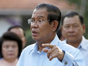 In this Feb. 25, 2018 photo, Cambodian Prime Minister Hun Sen, second from right, of ruling Cambodian People's Party speaks after his voting in the senate election at Takhmau polling station in Kandal province, southeast of Phnom Penh, Cambodia. Hun Sen has rejected a request from an opposition leader for talks about the country's political problems, denigrating archrival Sam Rainsy as a traitor and a convict.