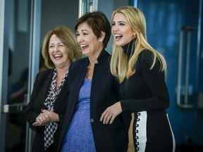 Ivanka Trump, right, and Iowa Gov. Kim Reynolds, center, share a laugh while touring the Waukee Innovation and Learning Center in Waukee, Iowa, Monday, March 19, 2018.