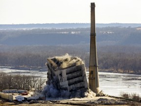 This Dec. 14, 2017 file photo shows the coal-fired Nelson Dewey Generating Station in Cassville, Wis., being imploded. The plant operated by Alliant Energy closed in 2015. The global fleet of coal-fired power plants is projected to begin shrinking by 2022 as plant retirements outpace new construction, according to a new report.