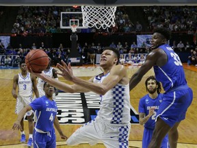 Kentucky forward Kevin Knox, center, gets around Buffalo forward Nick Perkins, right, for a shot during the second half of a second-round game in the NCAA men's college basketball tournament Saturday, March 17, 2018, in Boise, Idaho. Kentucky won 95-75.