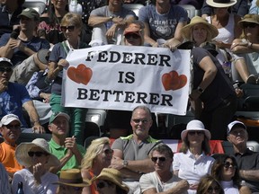 Fans hold up signs for Roger Federer, of Switzerland, during a semifinals match between Federer and Borna Coric, of Croatia, at the BNP Paribas Open tennis tournament, Saturday, March 17, 2018, in Indian Wells, Calif.
