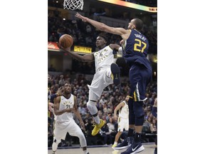 Indiana Pacers' Victor Oladipo is fouled by Utah Jazz's Rudy Gobert during the first half of an NBA basketball game Wednesday, March 7, 2018, in Indianapolis.