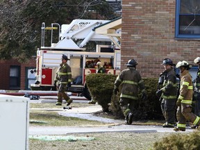 In this Sunday, March 25, 2018 photo, Gary fire and police crews respond to the scene of a deadly fire at the Lakeshore Dunes Apartments in Gary, Ind.  The cause is under investigation.