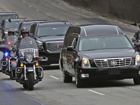 IMPD, Sheriff, and State Police officers travel on Meridian St. in Indianapolis as they escort the body of Boone Co. sheriff's deputy Jacob "Jake" Pickett from St. Vincent's Hospital downtown to the Marion County Coroner's office, Monday, Mar. 5, 2018. The officer, who was helping Lebanon police officers serve a warrant Friday, Mar. 2, 2018, was fatally wounded. He was taken off life support earlier this morning.