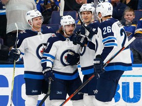 Winnipeg Jets forward Nic Petan is congratulated by teammates after scoring against the St. Louis Blues on Feb. 23.