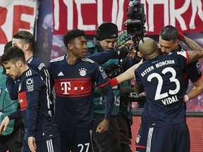 Bayern's Sandro Wagner, right, celebrates together with his teammates after scoring a goal during the German first division Bundesliga soccer match between RB Leipzig and Bayern Munich in Leipzig, Germany, Sunday, March 18, 2018.