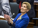 Ontario Premier Kathleen Wynne applauds while Ontario Finance Minister Charles Sousa (not pictured) delivers the provincial budget on Wednesday.