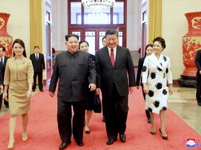In this March 26, 2018, photo, North Korean leader Kim Jong Un, center left, his wife Ri Sol Ju, left, are accompanied by Chinese counterpart Xi Jinping, center right, and his wife Peng Liyuan at the Great Hall of the People in Beijing. North Korea's leader Kim and his Chinese counterpart Xi sought to portray strong ties between the long-time allies despite a recent chill as both countries on Wednesday, March 28, 2018, confirmed Kim's secret trip to Beijing this week.  The content of this image is as provided and cannot be independently verified. Korean language watermark on image as provided by source reads: "KCNA" which is the abbreviation for Korean Central News Agency.  (Korean Central News Agency/Korea News Service via AP)