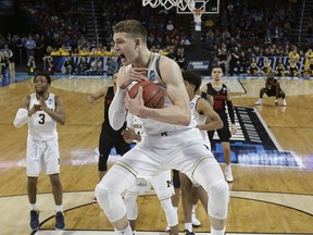 Michigan forward Moritz Wagner (13) grabs a rebound during the second half of the team's NCAA men's college basketball tournament second-round game against Houston on Saturday, March 17, 2018, in Wichita, Kan. Michigan won 64-63.