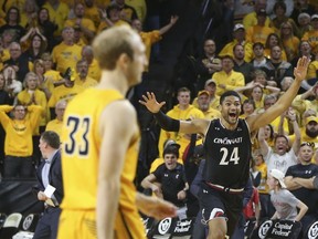 Cincinnati forward Kyle Washington (24) celebrates after Wichita State guard Conner Frankamp (33) missed a three-point basket that would have won an NCAA college basketball game in the American Athletic Conference tournament Sunday, March 4, 2018, in Wichita, Kan.