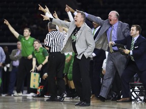 FILE - In this March 10, 2018, file photo, Marshall head coach Dan D'Antoni, front, tells his players to watch the play clock during a 67-66 win against Western Kentucky in an NCAA college basketball game in the finals of the Conference USA tournament in Frisco, Texas. D'Antoni was a 23-year-old assistant with the Marshall basketball program in 1970, when a plane carrying members of the Wichita State football team crashed in Colorado. Six weeks later, on Nov. 14, 1970, a plane carrying members of the Marshall football team crashed. As fate would have it, Marshall's first trip to the NCAA Tournament in 31 years means a date with Wichita State on Friday, March 16, 2018, in San Diego.